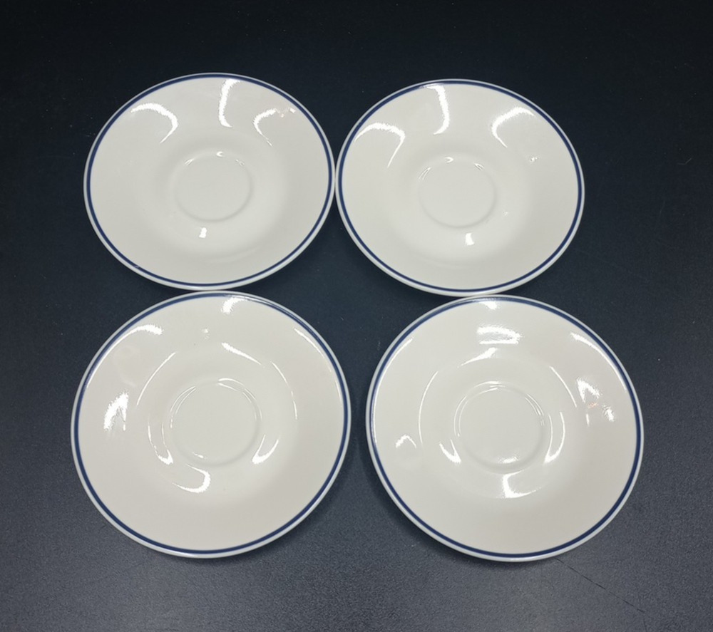 Corelle ivory saucer plates with dark blue ring